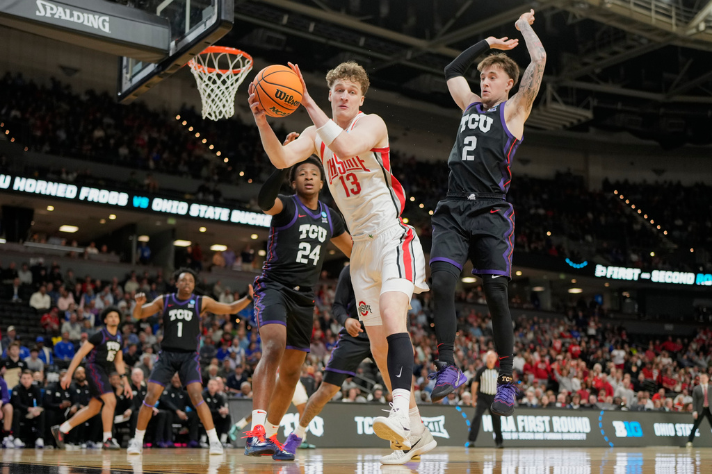 Ohio State center Christoph Tilly vies for the ball with TCU forward Xavier Edmonds, left, and guard Brock Harding during the first half in the first round of the NCAA college basketball tournament, Thursday, March 19, 2026, in Greenville, S.C. (AP Photo/Chris Carlson)