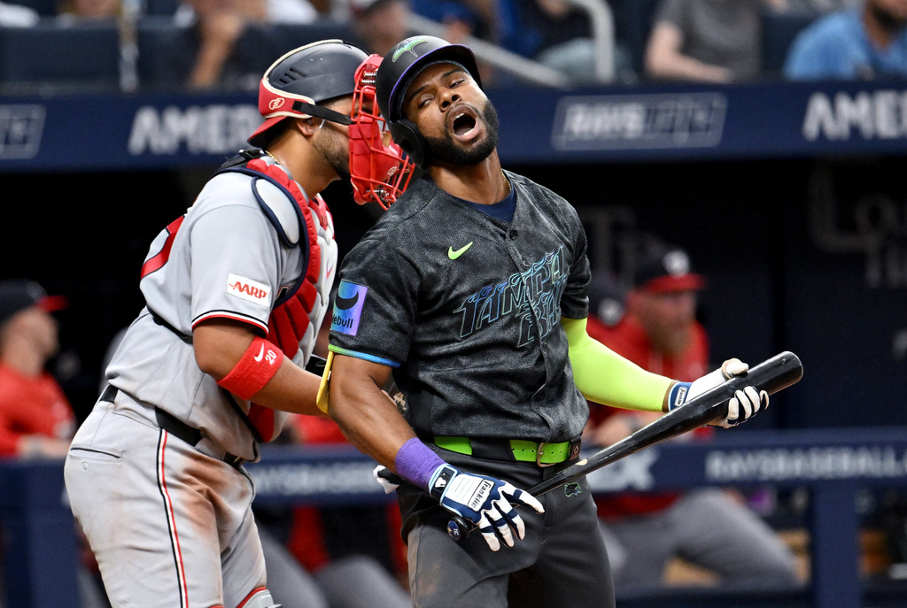 Tampa Bay Rays' Cedric Mullins, right, reacts after striking out during the ninth inning of a baseball game against the Washington Nationals, Saturday, June 20, 2026, in St. Petersburg, Fla. (AP Photo/Jason Behnken)