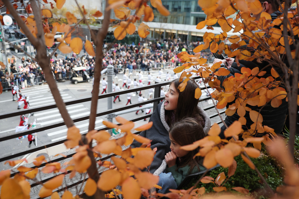 Spectators watch the Macy's Thanksgiving Day Parade as it marches down Sixth Avenue, Thursday, Nov. 27, 2025, in New York. (AP Photo/Heather Khalifa)