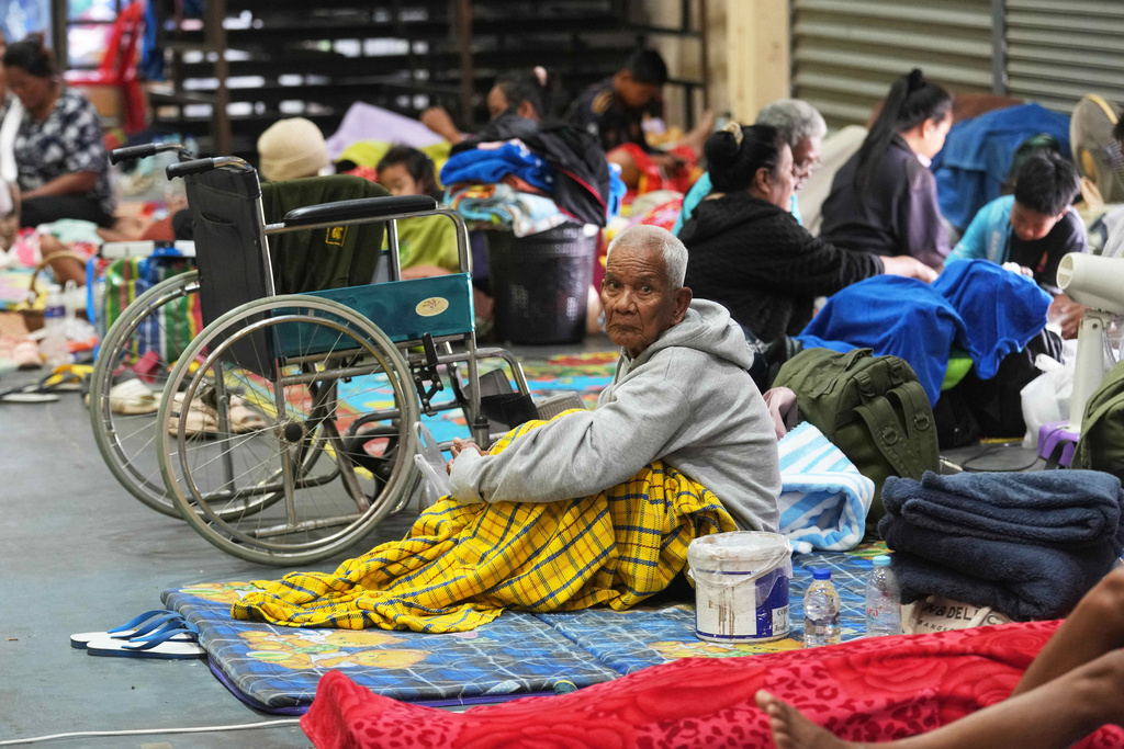 Thai residents who fled homes following the clashes between Thai and Cambodian soldiers, rest at an evacuation center in Surin province, Thailand, Wednesday, Dec. 10, 2025. (AP Photo/Sakchai Lalit)