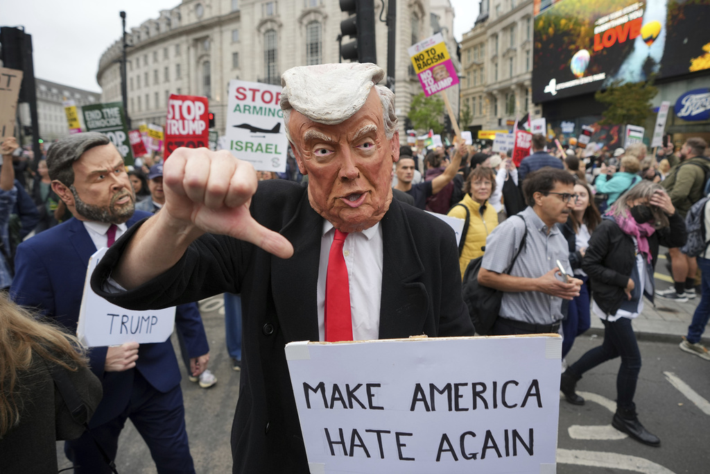 A protester wears a Trump mask during a demonstration of the Stop Trump Coalition group against President Donald Trump's state visit in London, Wednesday, Sept. 17, 2025.(AP Photo/Kin Cheung)
