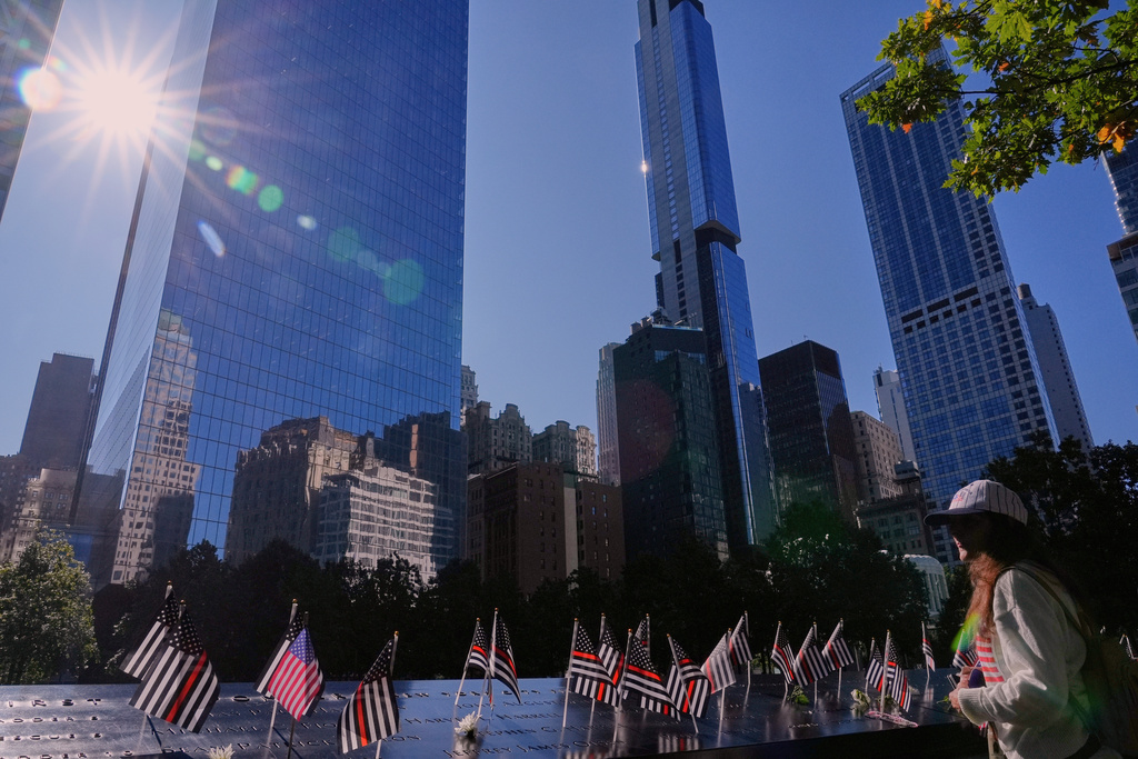 Mary Beth Delarm looks over the the names on the the 9/11 Memorial during a ceremony to mark the 24th anniversary of the 9/11 attacks, Thursday, Sept. 11, 2025, in New York. (AP Photo/Seth Wenig)