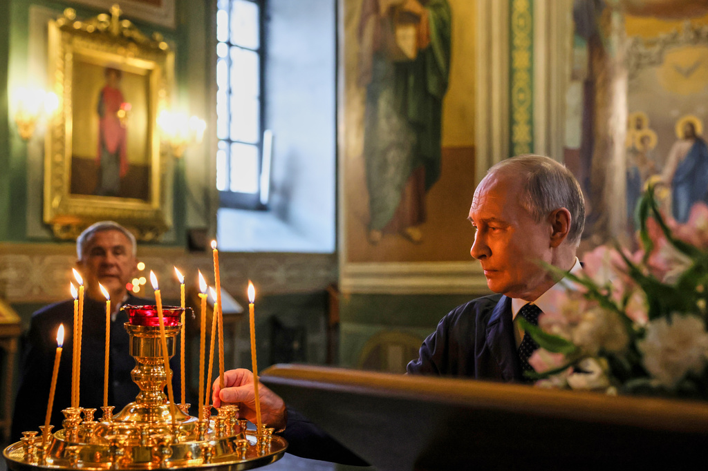 Russian President Vladimir Putin lights a candle while visiting the Annunciation Cathedral of the Kazan Kremlin during the Russia-ASEAN summit in Kazan, Russia, Wednesday, June 17, 2026. (Mikhail Metzel/Sputnik, Kremlin Pool Photo via AP)