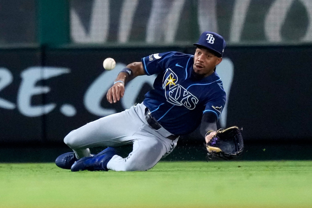 Tampa Bay Rays left fielder Chandler Simpson can't handle a ball hit for a single by Los Angeles Angels' Denzer Guzman during the seventh inning of a baseball game Saturday, June 13, 2026, in Anaheim, Calif. (AP Photo/Mark J. Terrill)
