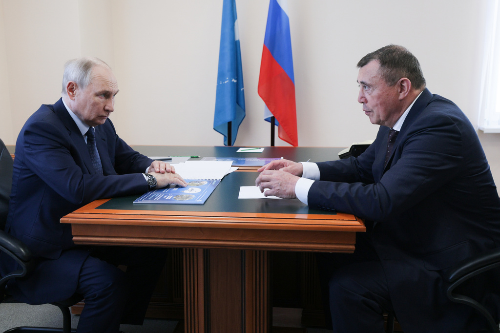 Russian President Vladimir Putin, left, listens to Sakhalin Region Governor Valery Limarenko in Kurilsk on the Iturup Island, the largest of the Kuril Islands of Russia's fareast, on Thursday, Aug. 13, 2026. (Gavriil Grigorov, Sputnik, Kremlin Pool Photo via AP)