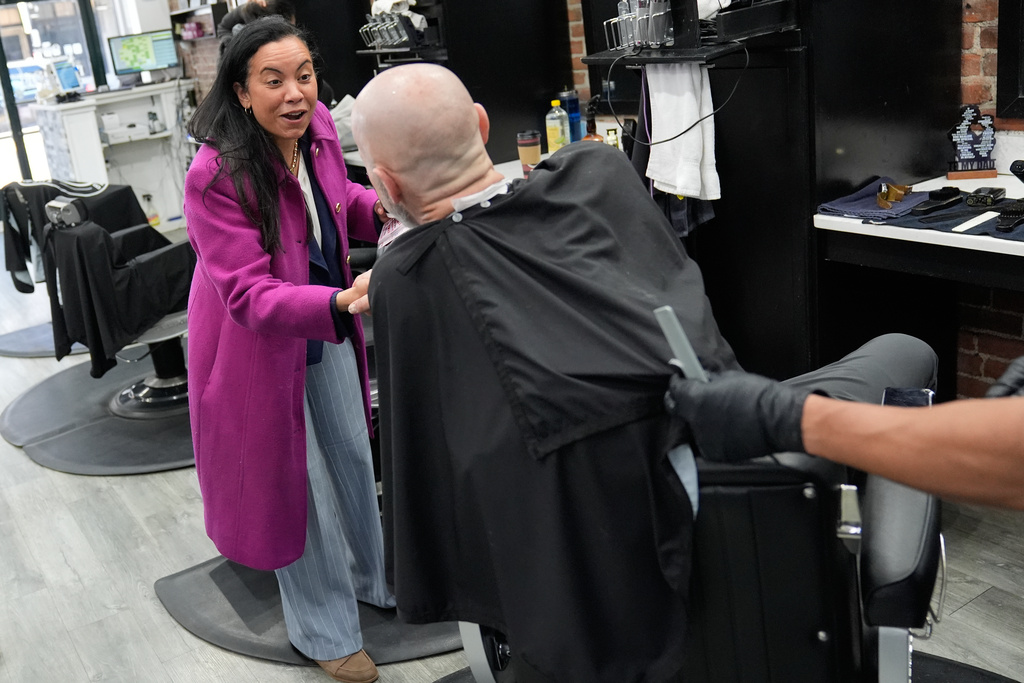 Analilia Mejia, the Democratic candidate running for New Jersey's 11th congressional district, talks to people at a barber shop in Morristown, N.J., Tuesday, March 24, 2026. (AP Photo/Seth Wenig)