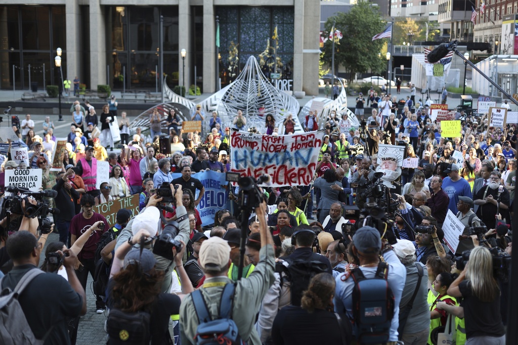 People attend a protest rally at the Immigration and Customs Enforcement field office in Baltimore, Monday, Aug. 25, 2025, to support Kilmar Abrego Garcia. (AP Photo/KT Kanazawich)