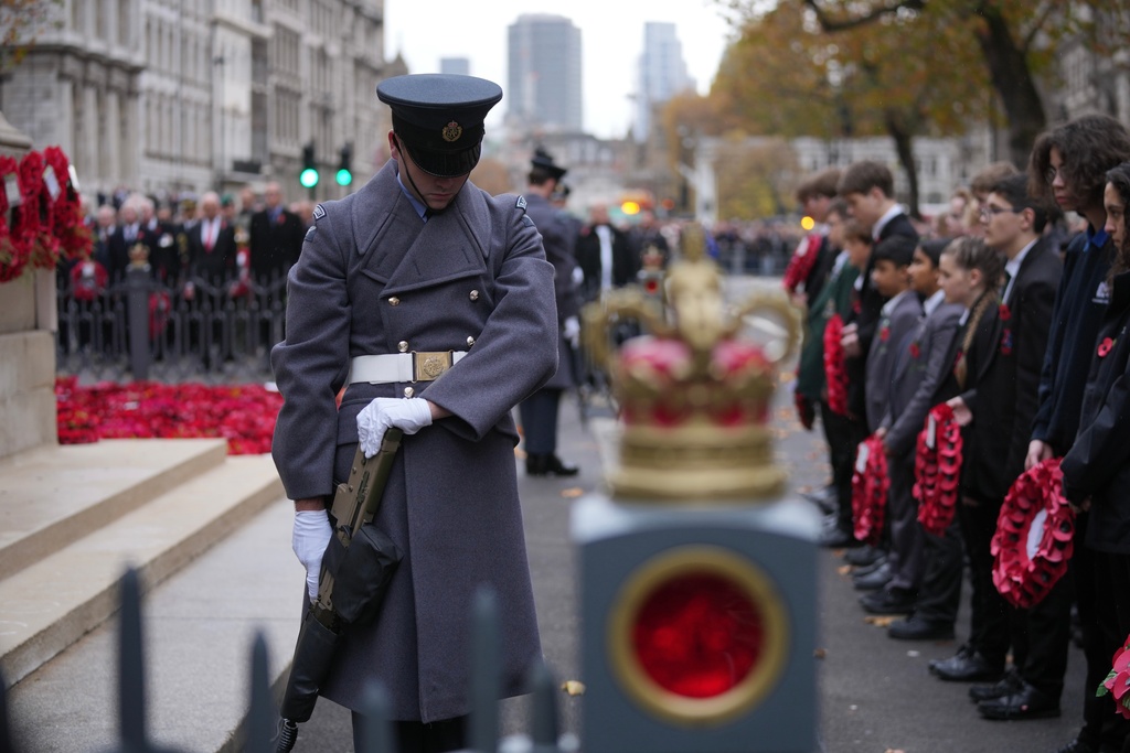 Soldiers stand at The Cenotaph on Armistice Day in London, Tuesday, Nov. 11, 2025. (AP Photo/Kin Cheung)