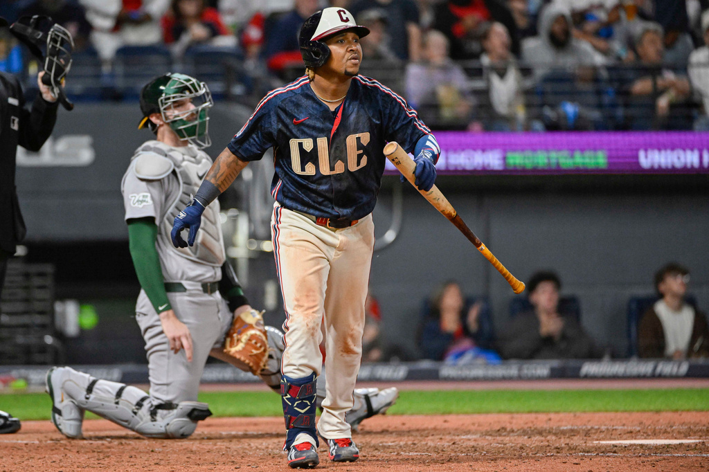 Cleveland Guardians' Jose Ramirez, right, watches his solo home run off Athletics relief pitcher Seth Johnson as Athletics catcher Jonah Heim, left, looks on during the sixth inning of a baseball game, Friday, Sept. 18, 2026, in Cleveland. (AP Photo/Phil Long)