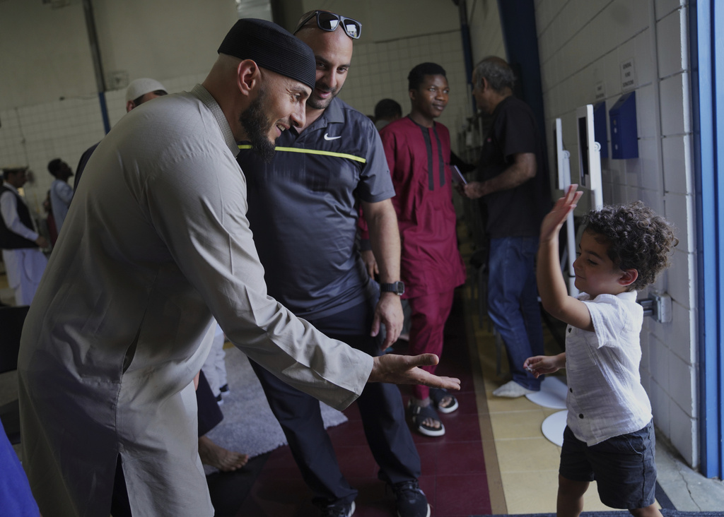Community members talk after Friday prayer at the Islamic Center of Cedar Rapids on Friday, Aug. 8, 2025, in Cedar Rapids, Iowa. (AP Photo/Jessie Wardarski)