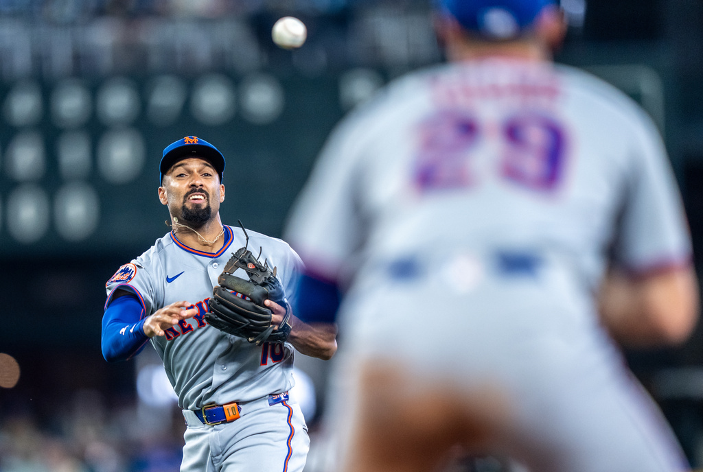 New York Mets second baseman Marcus Semien throws to first base for an out during the sixth inning of a baseball game against the Seattle Mariners, Wednesday, June 3, 2026, in Seattle. (AP Photo/Stephen Brashear)