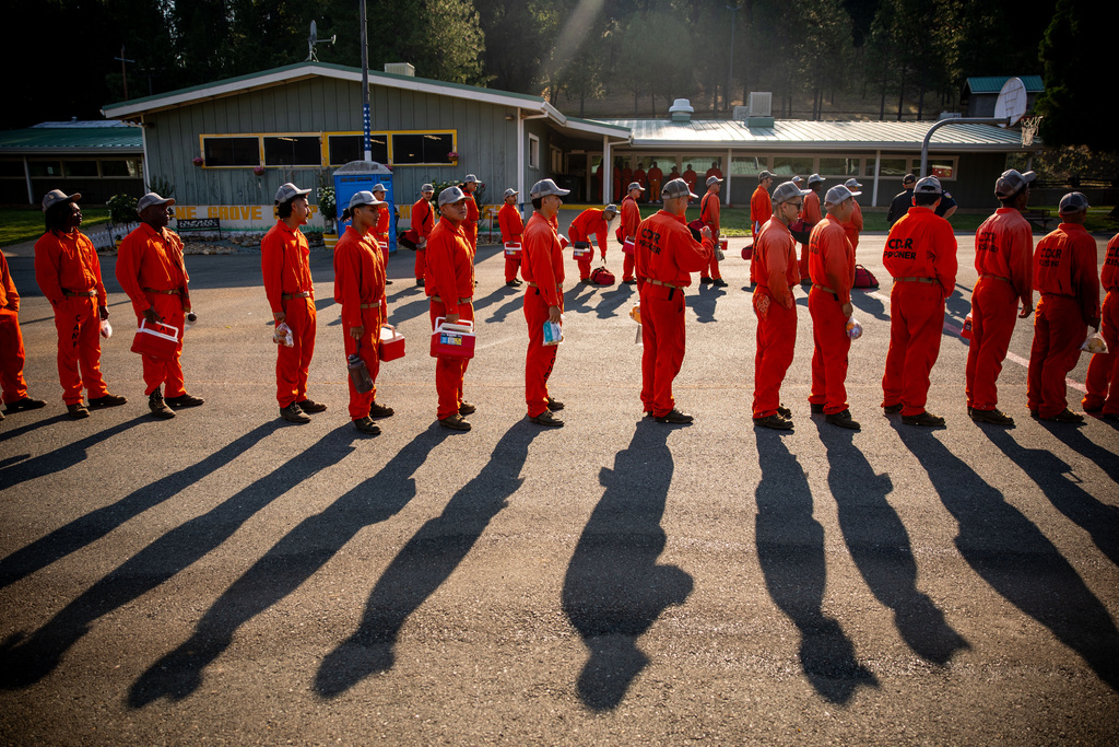 Participants in the Youth Offender Program Camp Pilot Program line up before work at the Pine Grove Youth Conservation Camp, July 14, 2025, in Red Corral, Calif. (AP Photo/Ethan Swope)
