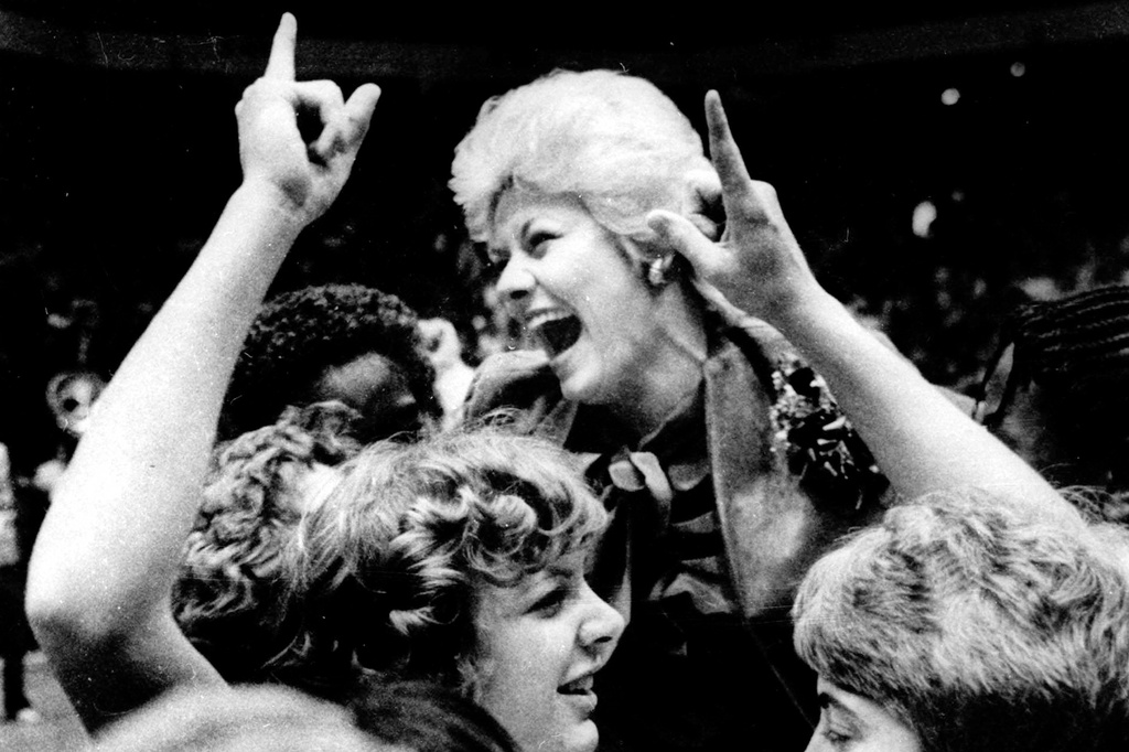 FILE - Louisiana Tech women's basketball coach Sonja Hogg is carried off the floor after defeating Tennesse in the AIAW national basketball championship, March 29, 1981, in Eugene, Ore, (AP Photo/Harley Soltes, File)