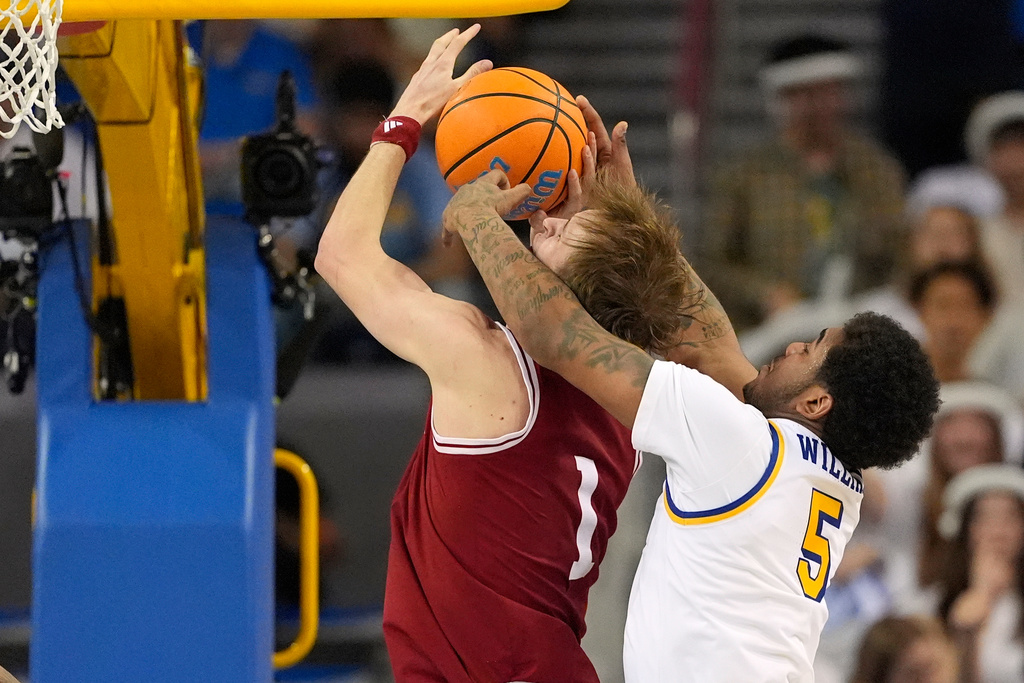 Indiana forward Reed Bailey, left, is fouled by UCLA guard Brandon Williams while shooting during the second half of an NCAA college basketball game, Saturday, Jan. 31, 2026, in Los Angeles. (AP Photo/Mark J. Terrill)