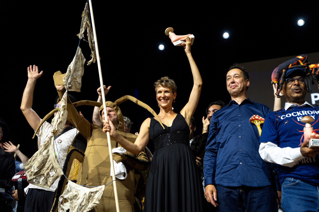 From left, Atlant Bieri, Pia Viviani and Marcel van der Heijden pose with the trophy during the Ig Nobel Prize ceremony held in the Zurich Convention Center in Zurich, Switzerland, on Thursday, Sept. 3, 2026. (Claudio Thoma/Keystone via AP)