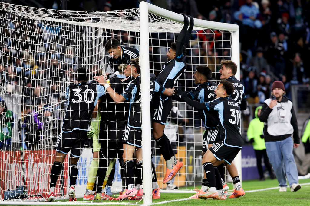 Minnesota United players celebrate after winning Game 3 in the first round of MLS soccer's Western Conference playoffs in a penalty shootout against the Seattle Sounders in St. Paul, Minn., Saturday, Nov. 8, 2025. (AP Photo/Ellen Schmidt)