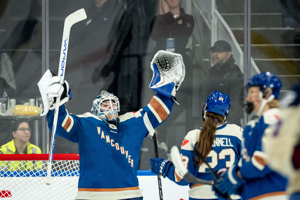 Vancouver Goldeneyes goaltender Kristen Campbell (50) celebrates with Mellissa Channell-Watkins (23) after defeating the Montreal Victoire in a PWHL hockey game, in Vancouver, on Tuesday, April 21, 2026. (Ethan Cairns/The Canadian Press via AP)