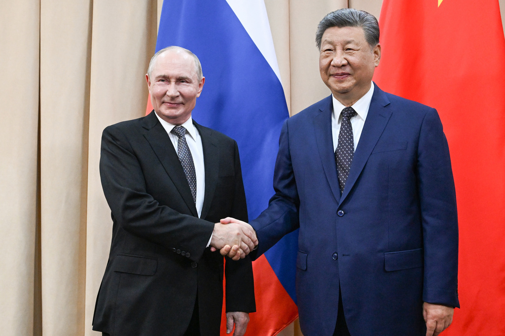 Russian President Vladimir Putin, left, and China's President Xi Jinping pose for photos during their meeting on the sidelines of the Shanghai Cooperation Organization (SCO), in Bishkek, Kyrgyzstan, on Monday, Aug. 31, 2026. (Kristina Solovyova, Sputnik, Kremlin Pool Photo via AP)