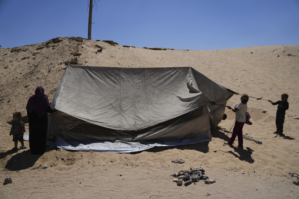 Members of the Abdullah family who were evacuated from Gaza City set up their tent in a camp for displaced Palestinians in Muwasi, an area that Israel has designated as a safe zone, in Khan Younis southern Gaza Strip, Wednesday, Sept. 10, 2025. (AP Photo/Jehad Alshrafi)