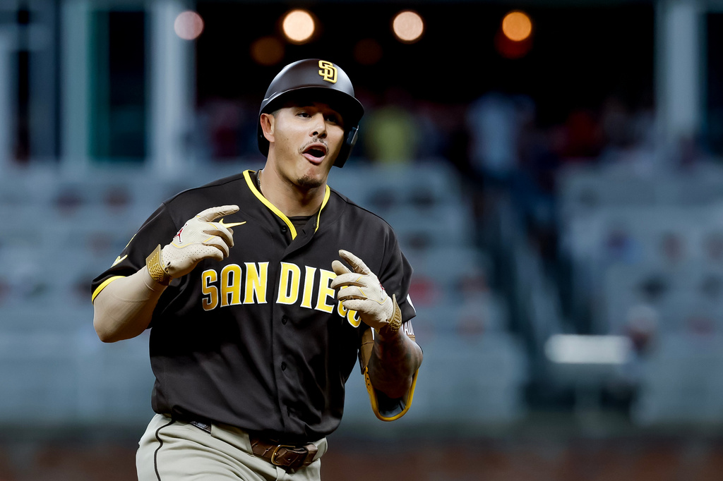 San Diego Padres' Manny Machado reacts while rounding the bases after hitting a solo home run against the Atlanta Braves during the sixth inning of a baseball game, Tuesday, July 21, 2026, in Atlanta. (AP Photo/Erik S. Lesser)