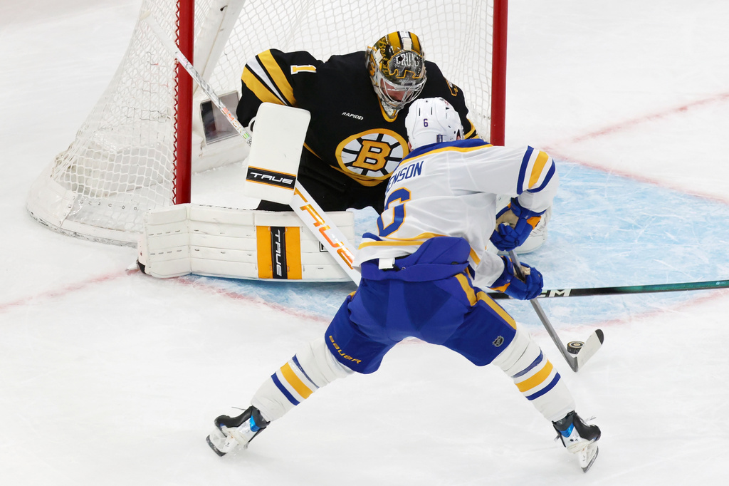 Buffalo Sabres' Zach Benson (6) scores on Boston Bruins' Jeremy Swayman (1) during the first period in Game 4 of a first-round NHL hockey Stanley Cup playoff series, Sunday, April 26, 2026, in Boston. (AP Photo/Michael Dwyer)