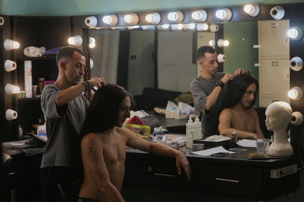 Alexandre Paulikevitch gets his wig adjusted by an assistant backstage before performing at a theatre in Beirut, Lebanon, Thursday, Sept. 11, 2025. (AP Photo/Hussein Malla)