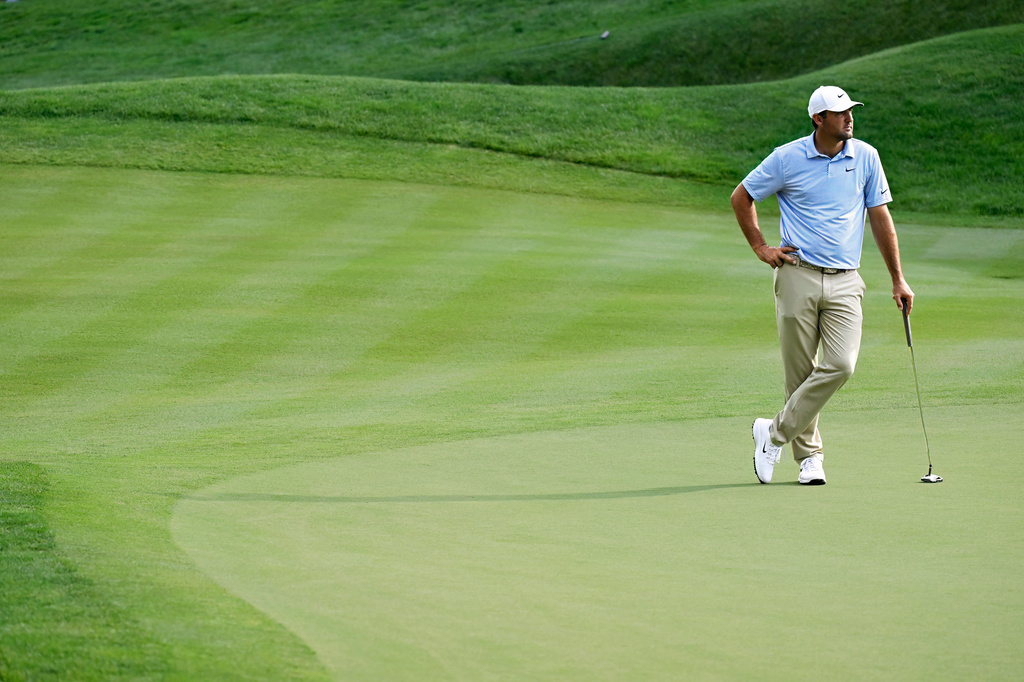 Scottie Scheffler watches play on the 18th hole during the first round of the Travelers Championship golf tournament at TPC River Highlands, Thursday, June 25, 2026, in Cromwell, Conn. (AP Photo/Jessica Hill)