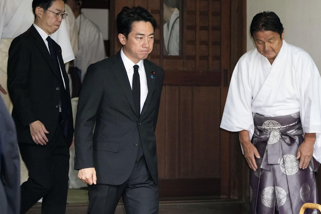 Japan's Defense Minister Shinjiro Koizumi, center, visits Yasukuni Shrine in Tokyo, Saturday, Aug. 15, 2026. (Kyodo News via AP)