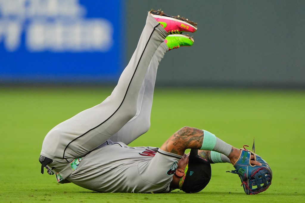 Arizona Diamondbacks second baseman Ketel Marte falls backwards after catching a line drive for the out on Kansas City Royals' Carter Jensen during the third inning of a baseball game, Tuesday, Sept. 8, 2026, in Kansas City, Mo. (AP Photo/Charlie Riedel)