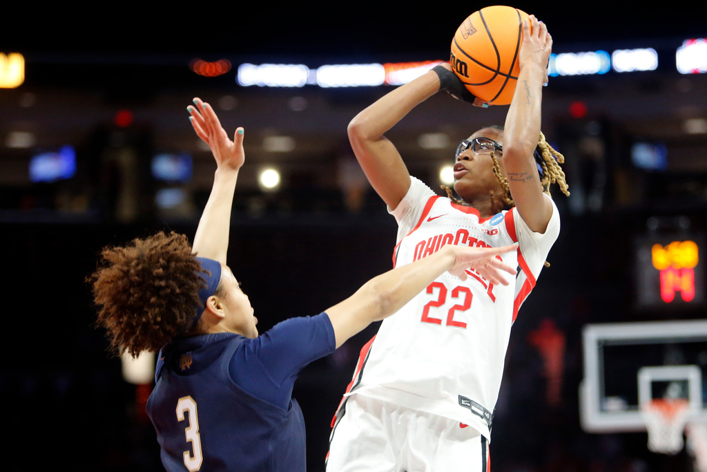 Ohio State guard Jaloni Cambridge (22) shoots over Notre Dame guard Hannah Hidalgo (3) during the first half in the second round of the NCAA college basketball tournament, Monday, March 23, 2026, in Columbus, Ohio. (AP Photo/Tom E. Puskar)