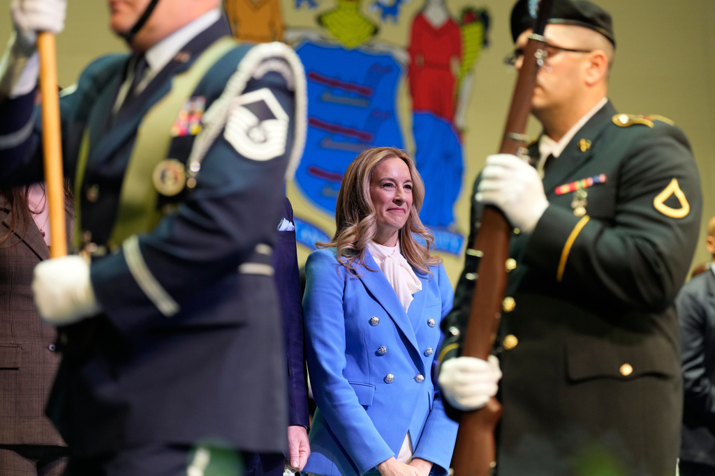 New Jersey Gov. Mikie Sherrill stands as an honor guard passes by during her inauguration ceremony in Newark, N.J., Tuesday, Jan. 20, 2026. (AP Photo/Seth Wenig)