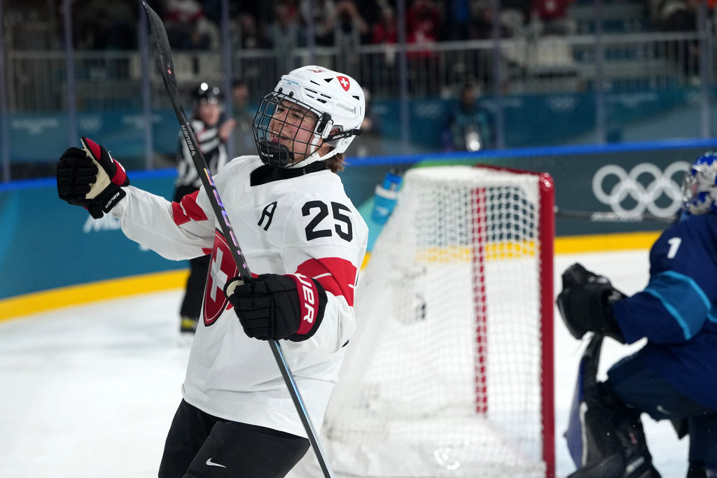 Switzerland's Alina Muller (25) celebrates after scoring against Finland goalkeeper Sanni Ahola (1) during the second period of a women's ice hockey quarterfinal match at the 2026 Winter Olympics, in Milan, Italy, Saturday, Feb. 14, 2026. (AP Photo/Carolyn Kaster)