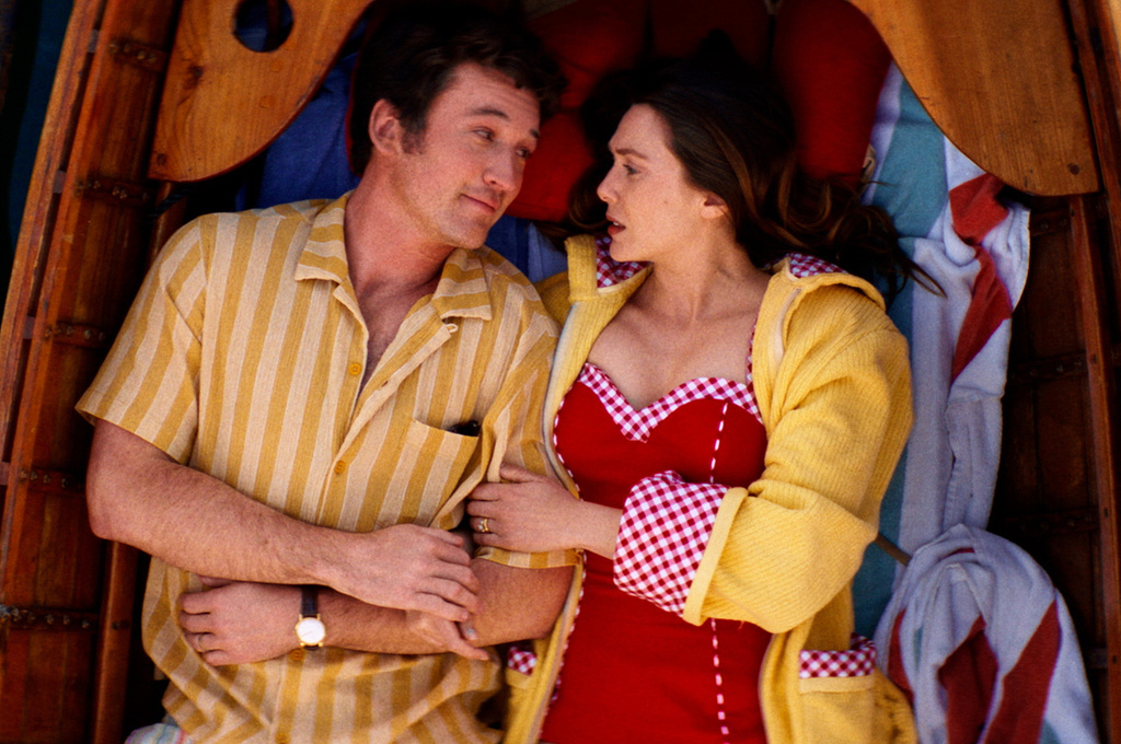 This image released by A24 shows Miles Teller, left, and Elizabeth Olsen in a scene from "Eternity." (A24 via AP)