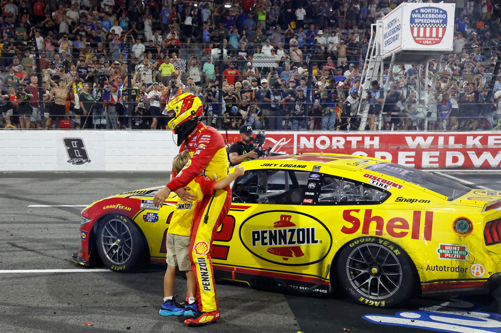 Joey Logano hugs his son Hudson after winning a NASCAR Cup Series auto race in North Wilkesboro, N.C., Sunday, July 19, 2026. (AP Photo/Terry Renna)