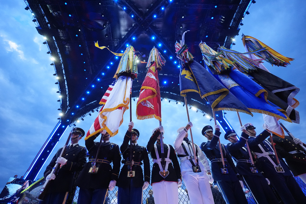 A joint forces honor guard stands during the National Anthem before UFC Freedom 250 on the South Lawn of the White House, Sunday, June 14, 2026, in Washington. (AP Photo/Alex Brandon)