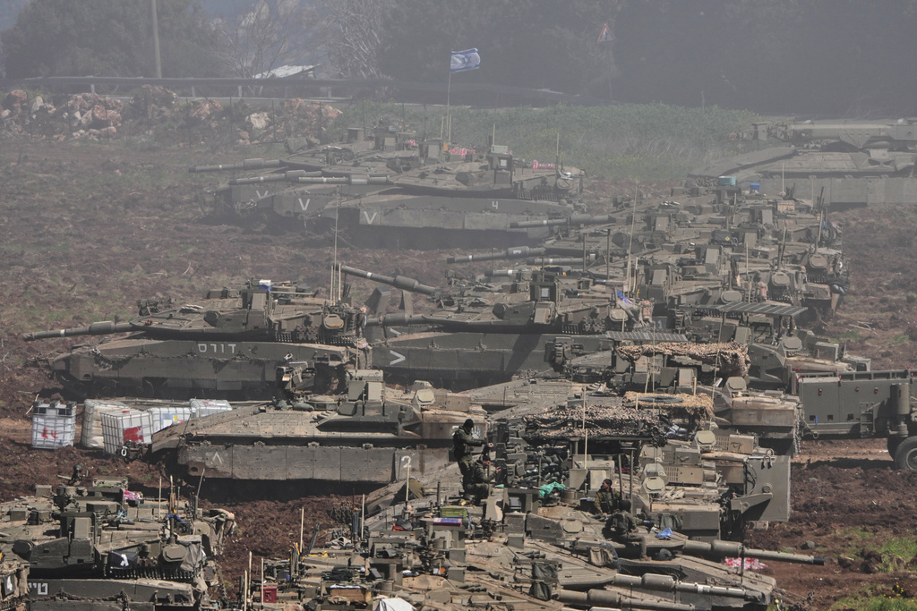 Israeli tanks are parked in a staging area in northern Israel near the border with Lebanon, Israel, Sunday, March 8, 2026. (AP Photo/Ariel Schalit)