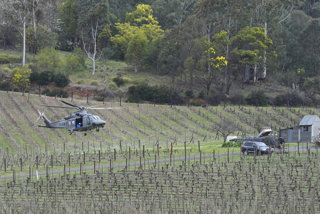 Police board a helicopter takes off from a command area at Feathertop Winery in Porepunkah in Victoria, Australia, Wednesday, Aug. 27, 2025. (Simon Dallinger/AAP Image via AP)