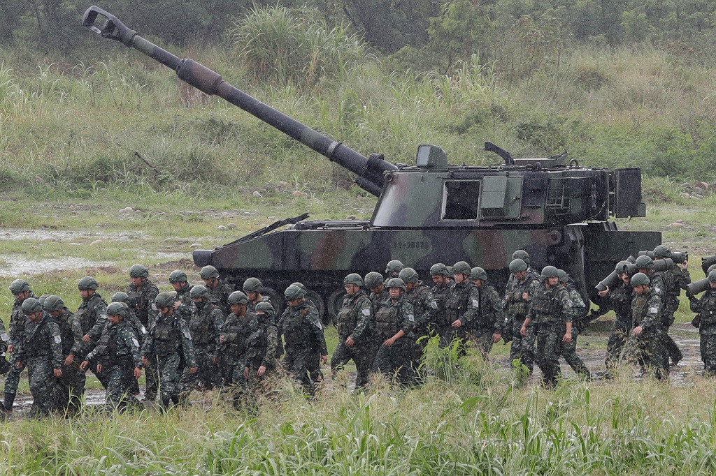 Soldiers move past a self-propelled howitzer during a military live-fire shooting training in Taichung City, Taiwan, Tuesday, June 9, 2026. (AP Photo/Chiang Ying-ying)