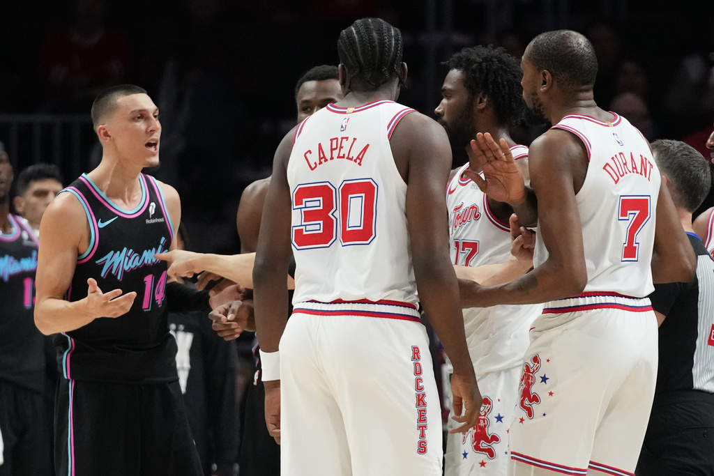 Miami Heat guard Tyler Herro (14) and Houston Rockets forward Kevin Durant (7) exchange words during the first half of an NBA basketball game, Saturday, Feb. 28, 2026, in Miami. (AP Photo/Lynne Sladky)