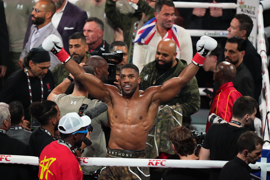 Anthony Joshua celebrates after his win in the heavyweight boxing match against Jake Paul, Friday, Dec. 19, 2025, in Miami, Fla. (AP Photo/Lynne Sladky)