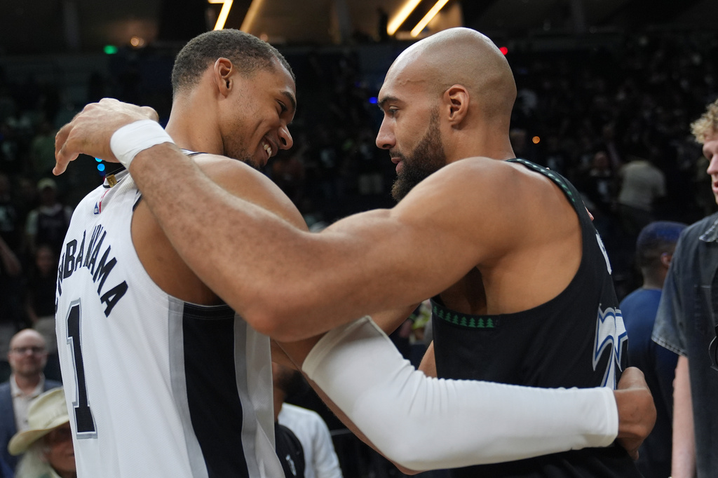 San Antonio Spurs forward Victor Wembanyama, left, and Minnesota Timberwolves center Rudy Gobert, right, greet following Game 6 of an NBA basketball second-round playoffs series in Minneapolis, Friday, May 15, 2026. (AP Photo/Abbie Parr)