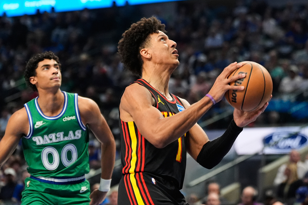Atlanta Hawks forward Jalen Johnson (1) drives to the basket past Dallas Mavericks guard Max Christie (00) in the first half of a NBA basketball game in Dallas, Wednesday, March 18, 2026. (AP Photo/Tony Gutierrez)