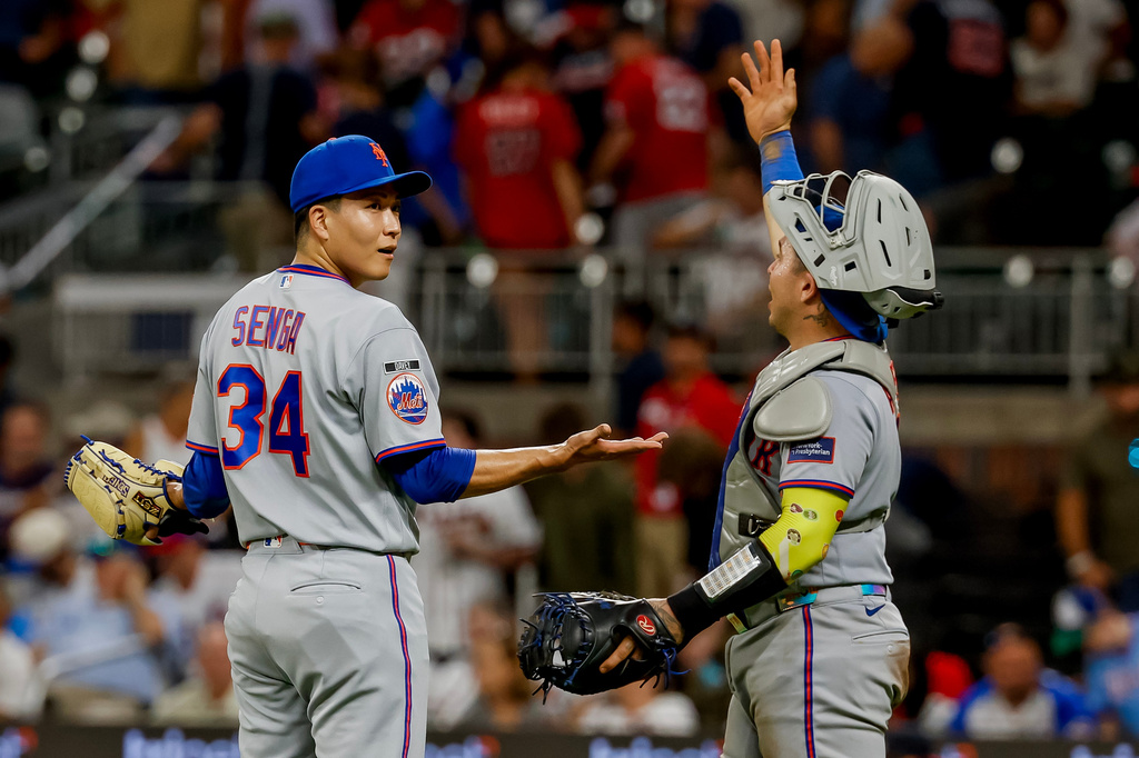 New York Mets pitcher Kodai Senga, left, reacts with catcher Francisco Alvarez, right, after closing out the Atlanta Braves during the ninth inning of a baseball game, Monday, Aug. 10, 2026, in Atlanta. (AP Photo/Erik S. Lesser)
