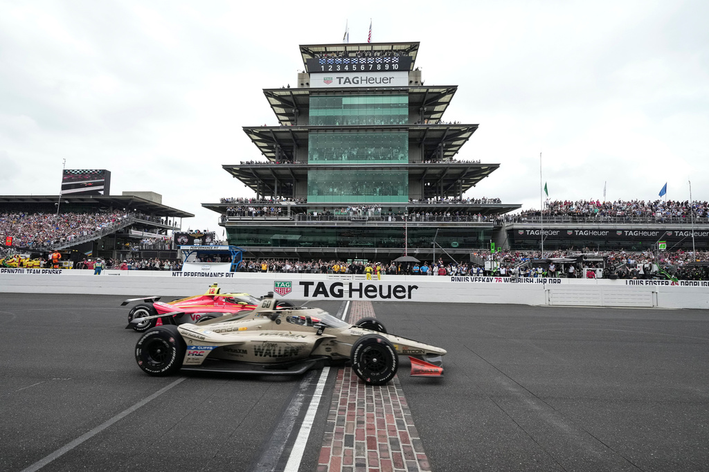 Felix Rosenqvist, foreground, of Sweden, beats David Malukas to the finish line to win the Indianapolis 500 auto race at Indianapolis Motor Speedway in Indianapolis, Sunday, May 24, 2026. (AP Photo/AJ Mast)