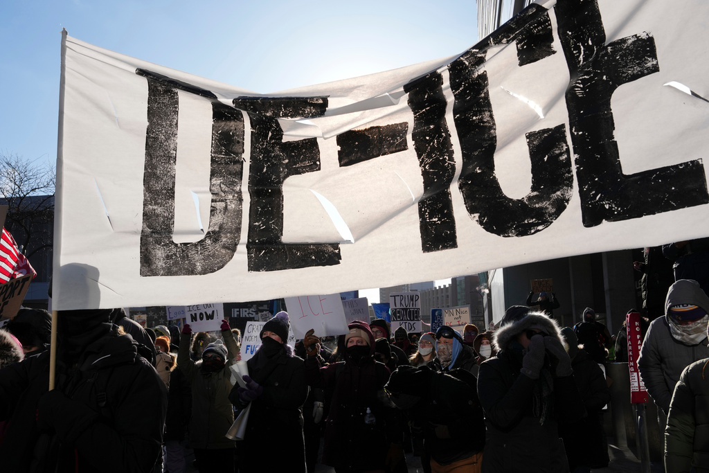 People protest against ICE (Immigration and Customs Enforcement) in Minneapolis, Sunday, Jan. 25, 2026. (AP Photo/Adam Gray)