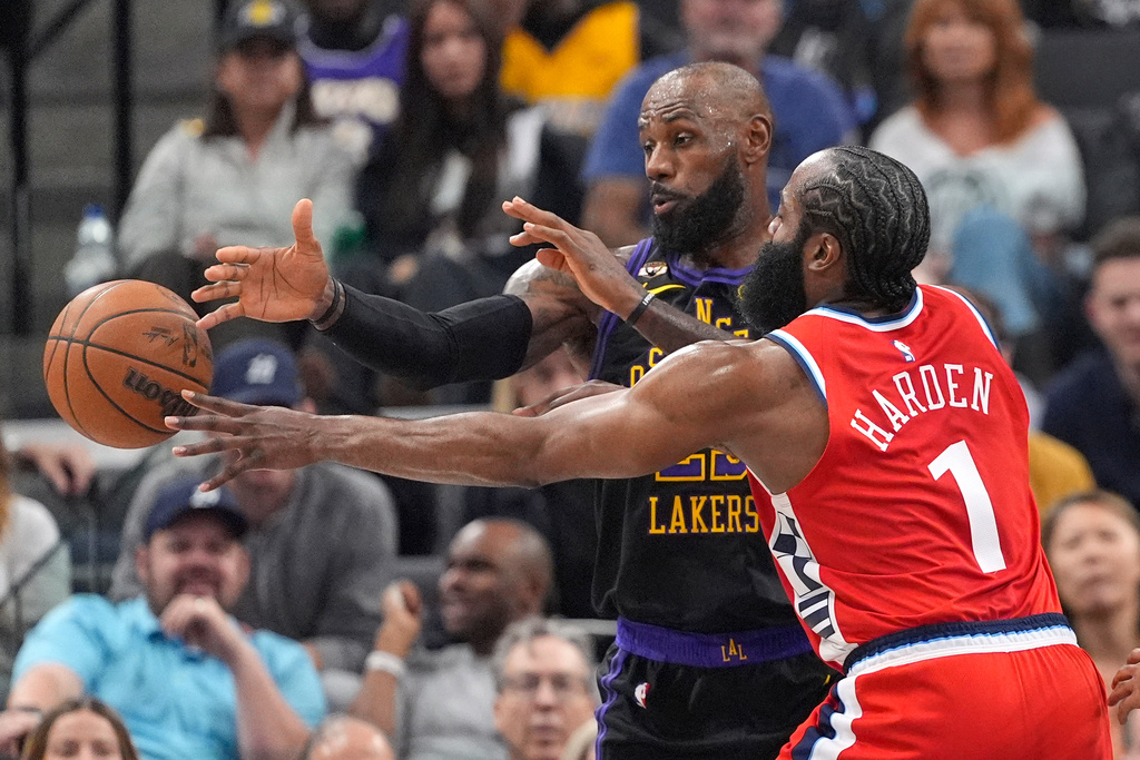 Los Angeles Clippers guard James Harden, right, passes as Los Angeles Lakers forward LeBron James defends during the first half of an NBA basketball game Thursday, Jan. 22, 2026, in Inglewood, Calif. (AP Photo/Mark J. Terrill)