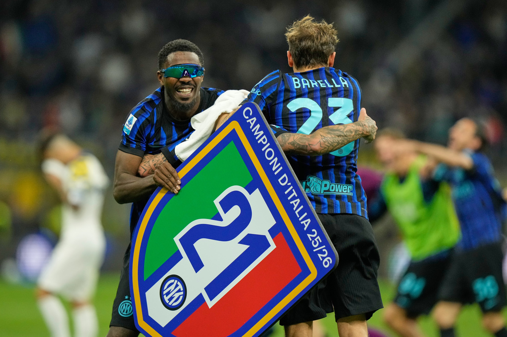 Inter Milan's Marcus Thuram, left, and Inter Milan's Nicolo Barella celebrate their victory at the Serie A soccer match between Inter Milan and Parma, in Milan, Italy, Sunday, May 3, 2026. (AP Photo/Luca Bruno)