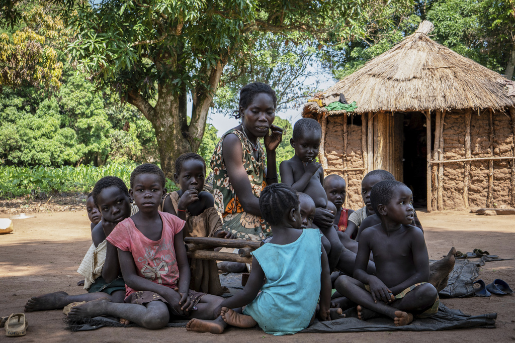 Vobia Kawaja, a 34-year-old mother of five, sits outside her home with her children and neighbors' children in Kotobi, Mundri West County, South Sudan, June 26, 2025. (AP Photo/Florence Miettaux)