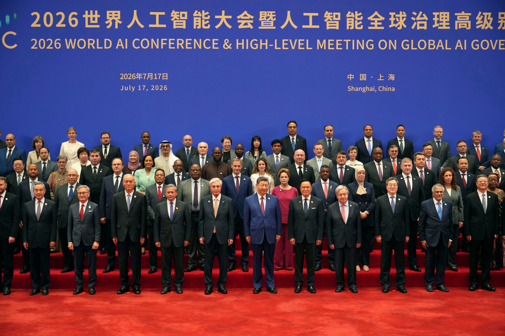 Chinese President Xi Jinping, center takes a group photo with other attendees before the opening ceremony for the World AI Conference in Shanghai, Friday, July 17, 2026. (AP Photo/Ng Han Guan, Pool)