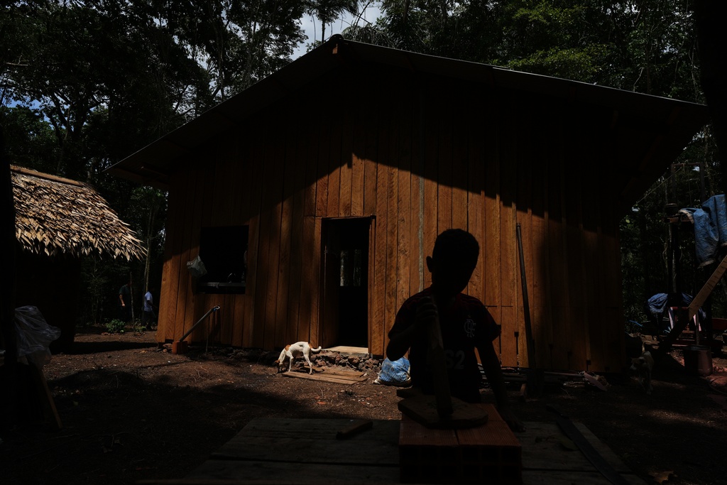 Riquelme plays in the backyard of his home at a quilombola, an Afro-descendant community called Menino Jesus, in Acara, Brazil, Tuesday, Nov. 18, 2025. (AP Photo/Fernando Llano)